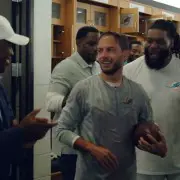 Coach Mike McDaniel gets the game ball after winning his first game as Dolphins coach.