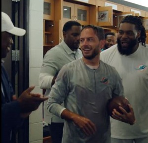 Coach Mike McDaniel gets the game ball after winning his first game as Dolphins coach.