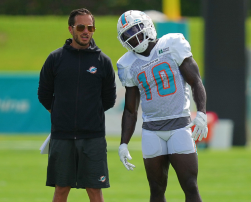 Tyreek Hill stands with head coach Mike McDaniel during practice