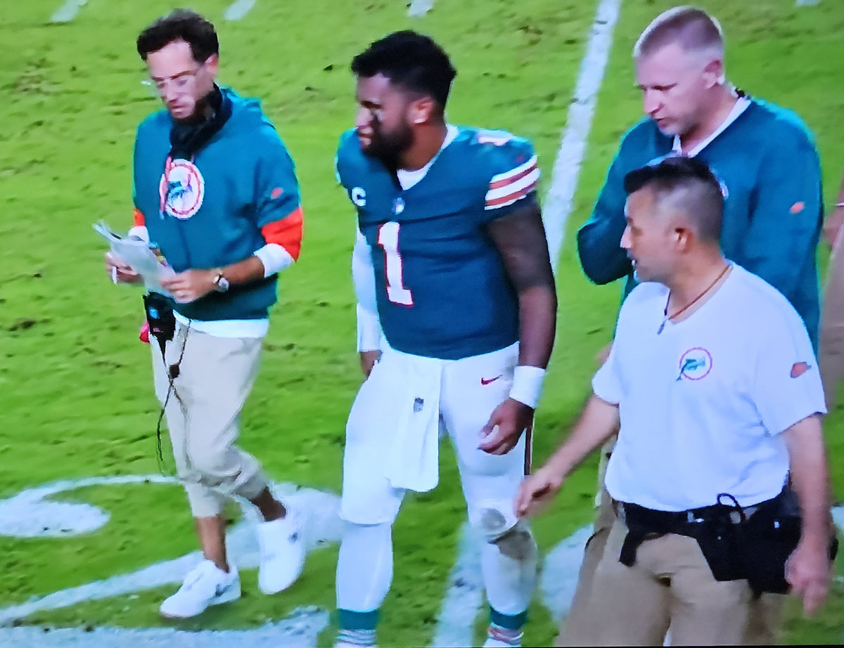 Dolphins quarterback Tua Tagovailoa walks off the field with coach Mike McDaniel and trainers after sustaining a concussion Thursday night against the Buffalo Bills.